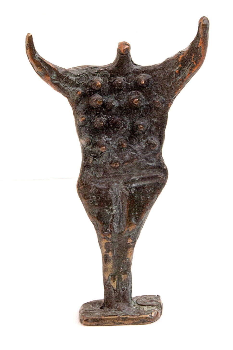 Bronze female figure with outstretched arms and many breasts.